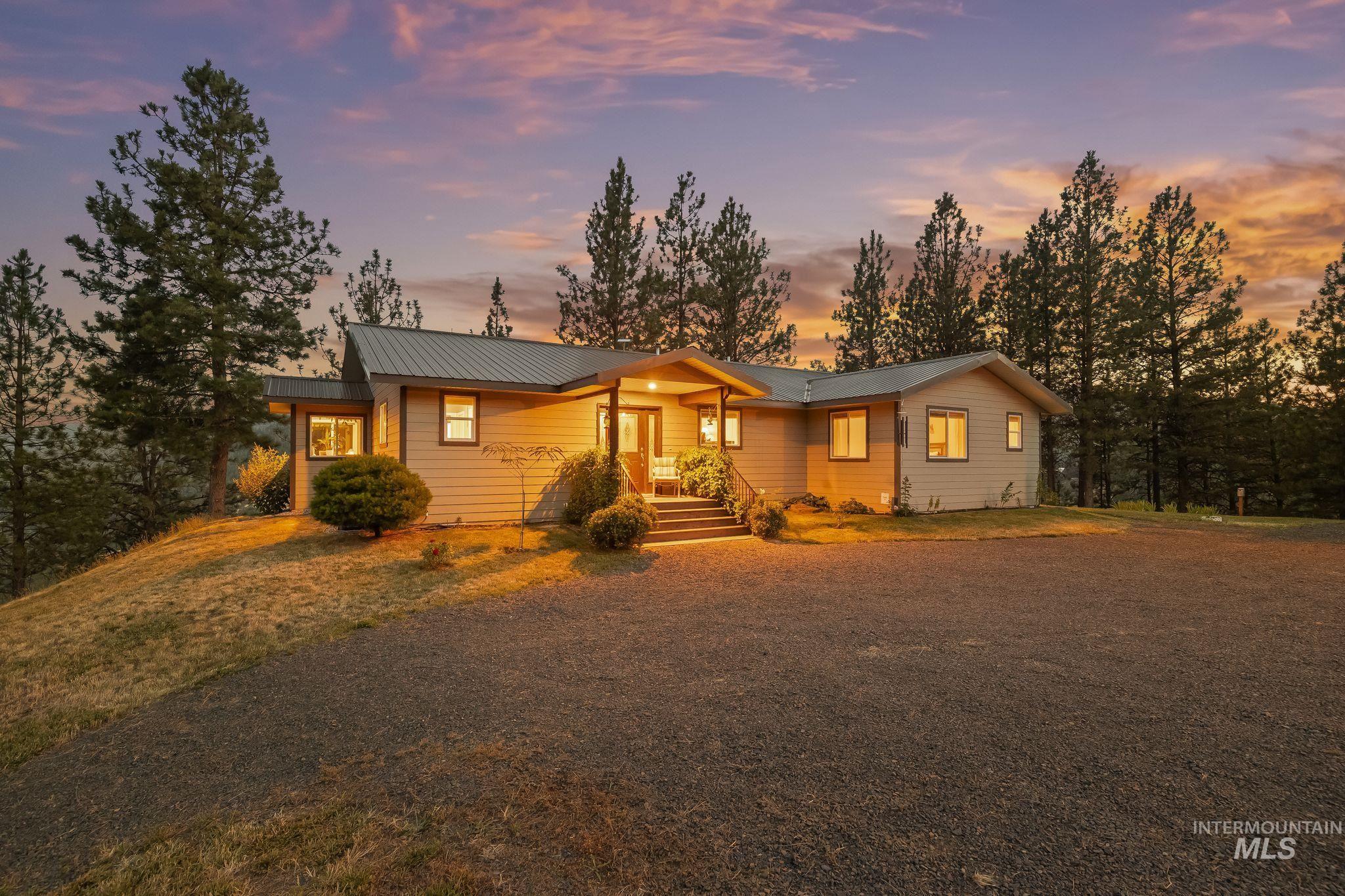 435 River Pointe Lane Lenore, ID 83541 - Photo 5 of 50 Siding exterior with a metal roof and covered entry