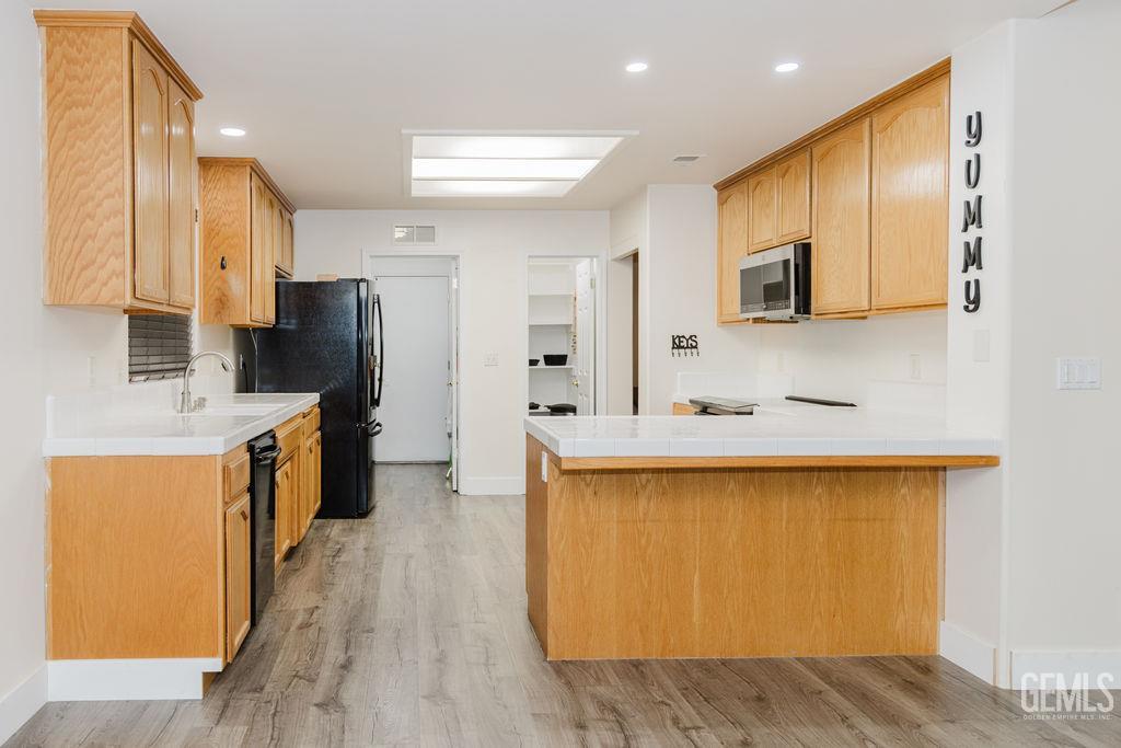Undisclosed Address Bakersfield, CA 93308 - Photo 11 of 45 a large kitchen with stainless steel appliances a sink a refrigerator and a microwave