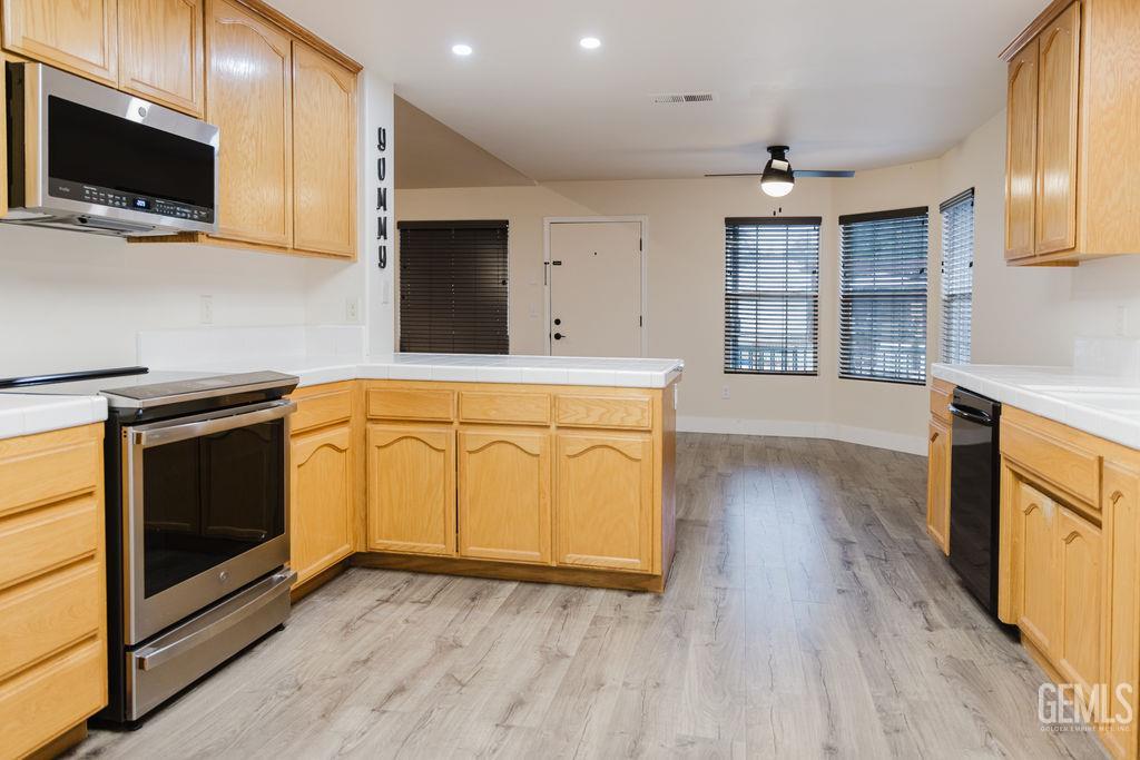 Undisclosed Address Bakersfield, CA 93308 - Photo 12 of 45 a kitchen with stainless steel appliances granite countertop a stove a sink and a microwave