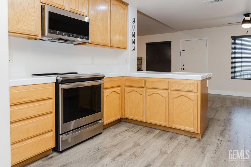 Undisclosed Address Bakersfield, CA 93308 - Photo 14 of 45 a kitchen with stainless steel appliances granite countertop a stove microwave and sink
