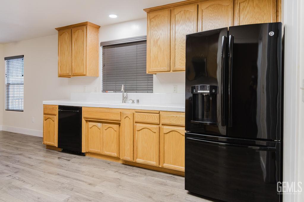 Undisclosed Address Bakersfield, CA 93308 - Photo 17 of 45 a kitchen with a refrigerator and a sink