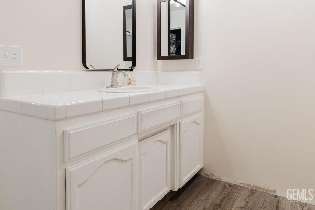 Undisclosed Address Bakersfield, CA 93308 - Photo 36 of 45 a bathroom with a sink and a mirror