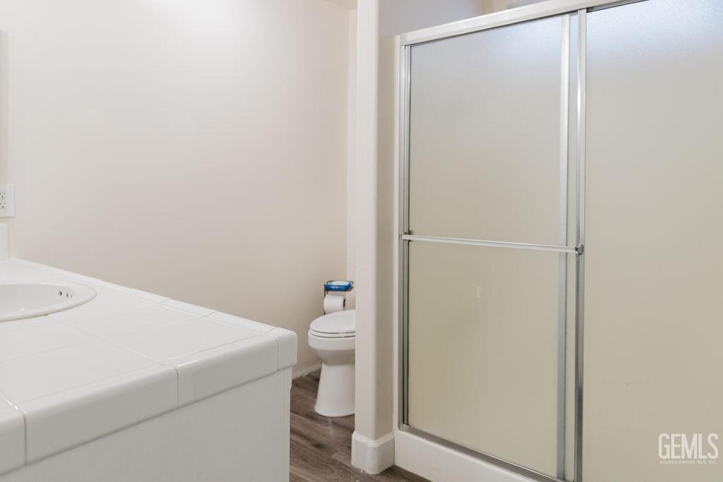 Undisclosed Address Bakersfield, CA 93308 - Photo 38 of 45 a white toilet sitting next to a shower