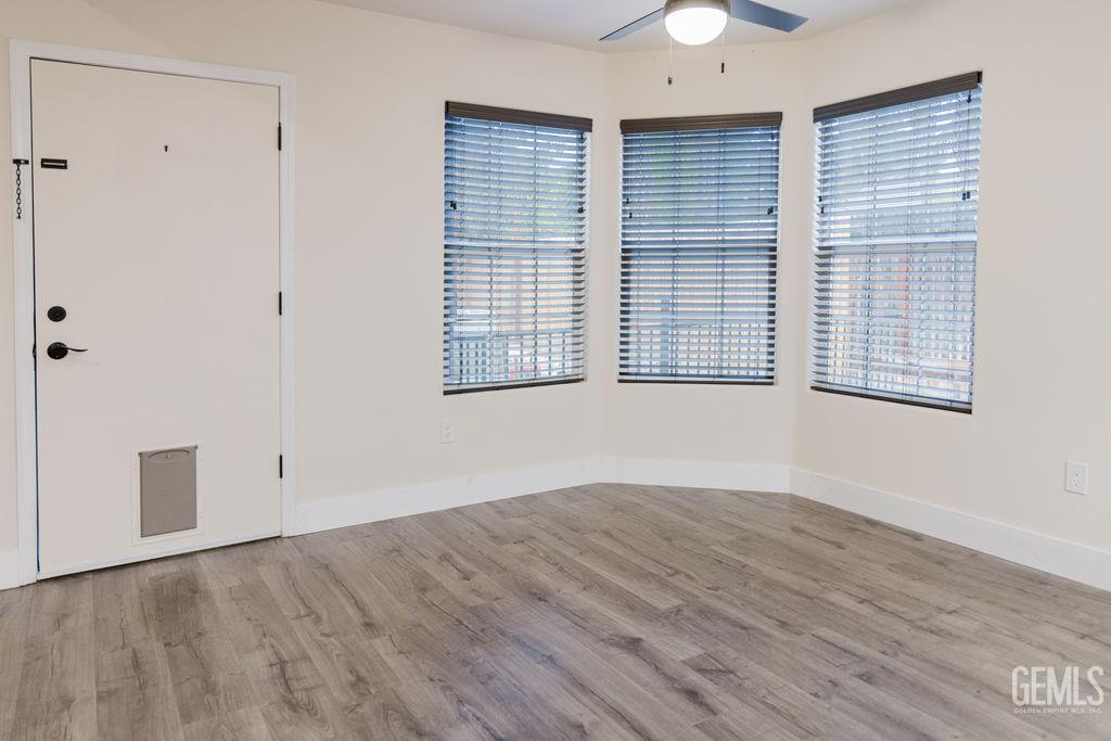 Undisclosed Address Bakersfield, CA 93308 - Photo 9 of 45 wooden floor in an empty room with a window
