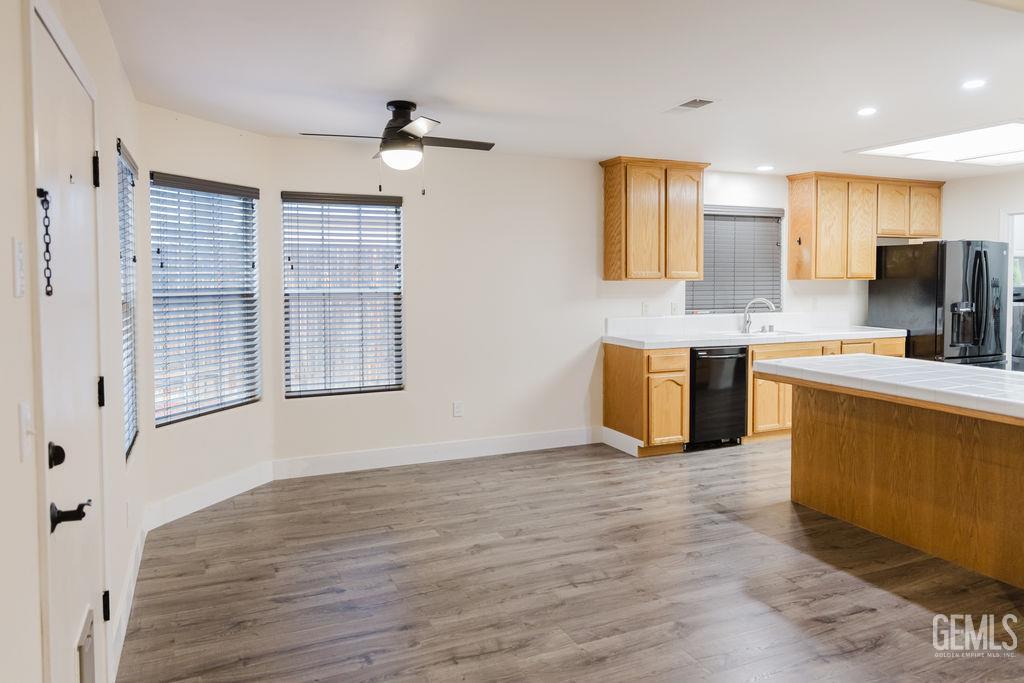Undisclosed Address Bakersfield, CA 93308 - Photo 10 of 45 a kitchen with stainless steel appliances granite countertop a sink dishwasher a stove and a refrigerator with wooden floor