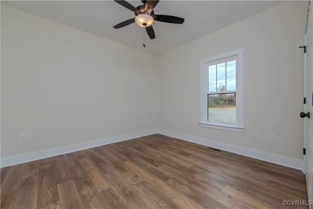 wooden floor in an empty room with a window