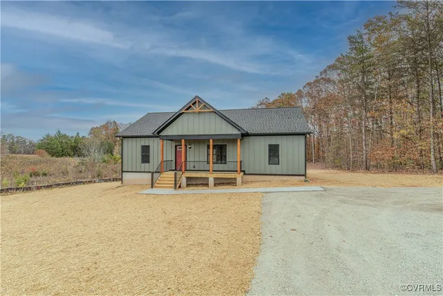 a view of house with yard and sitting area