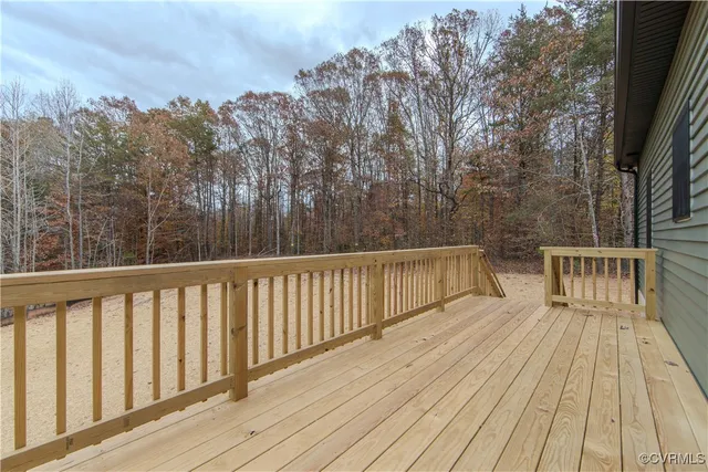 a view of balcony with wooden floor and fence