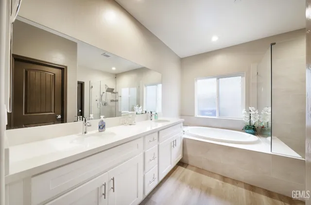 a bathroom with a tub and mirror