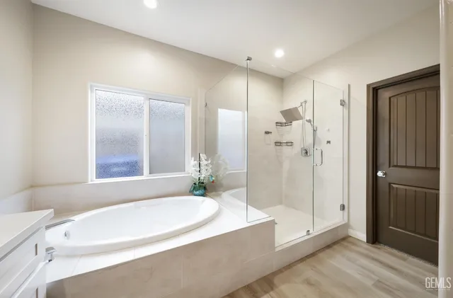 a bathroom with a sink a toilet and a large mirror