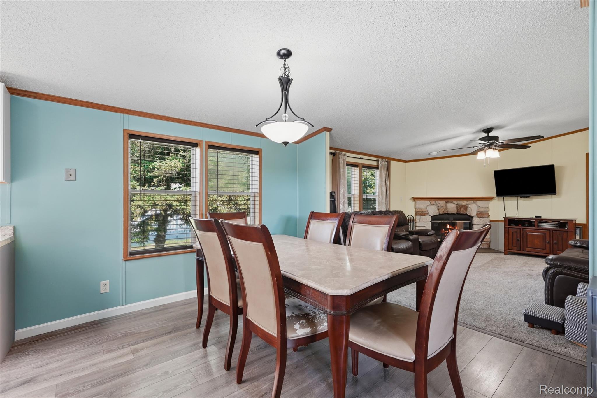 4634 Butternut Street Clarkston, MI 48348 - Photo 10 of 28 Dining area featuring wood-finish flooring and a contemporary chandelier