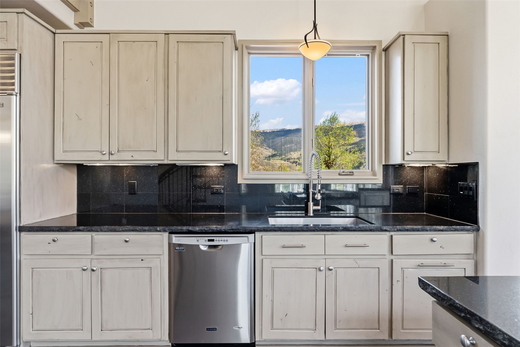 2800 Hunter's Knob Road Silverthorne, CO 80498 - Photo 12 of 37 a kitchen with white cabinets and window