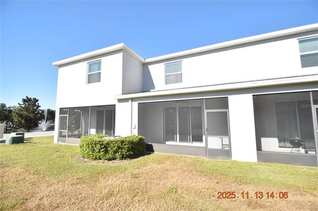a view of a house with backyard and sitting area