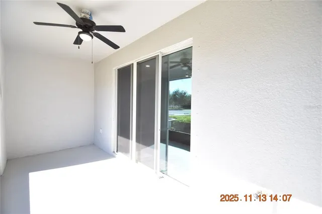 a view of a room with a ceiling fan