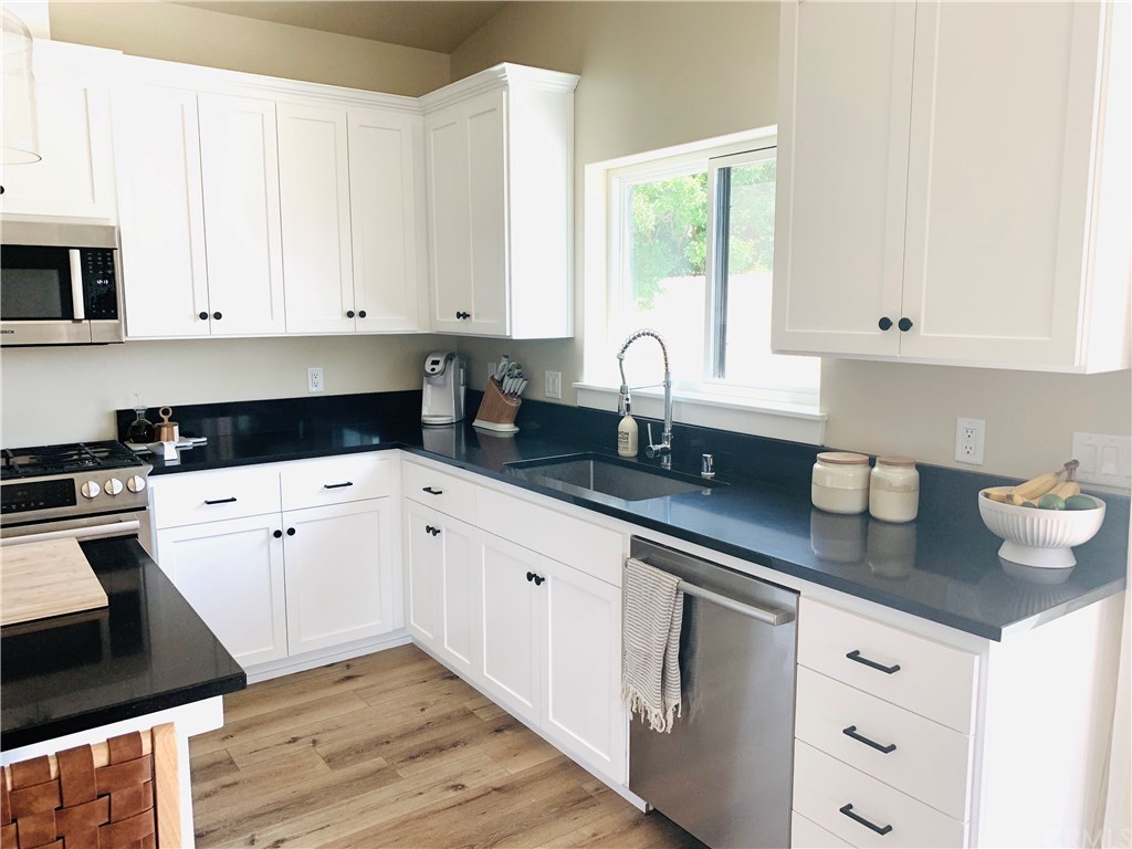 196 Rowan Way Templeton, CA 93465 - Photo 15 of 32 a kitchen with granite countertop white cabinets white appliances and a sink