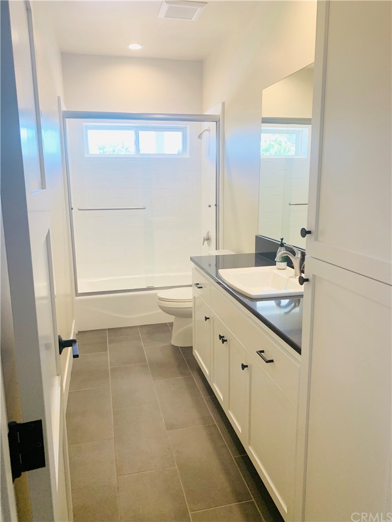 196 Rowan Way Templeton, CA 93465 - Photo 21 of 32 a bathroom with a granite countertop sink mirror vanity and a bathtub
