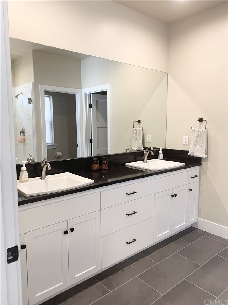 196 Rowan Way Templeton, CA 93465 - Photo 29 of 32 a bathroom with a double vanity sink and mirror