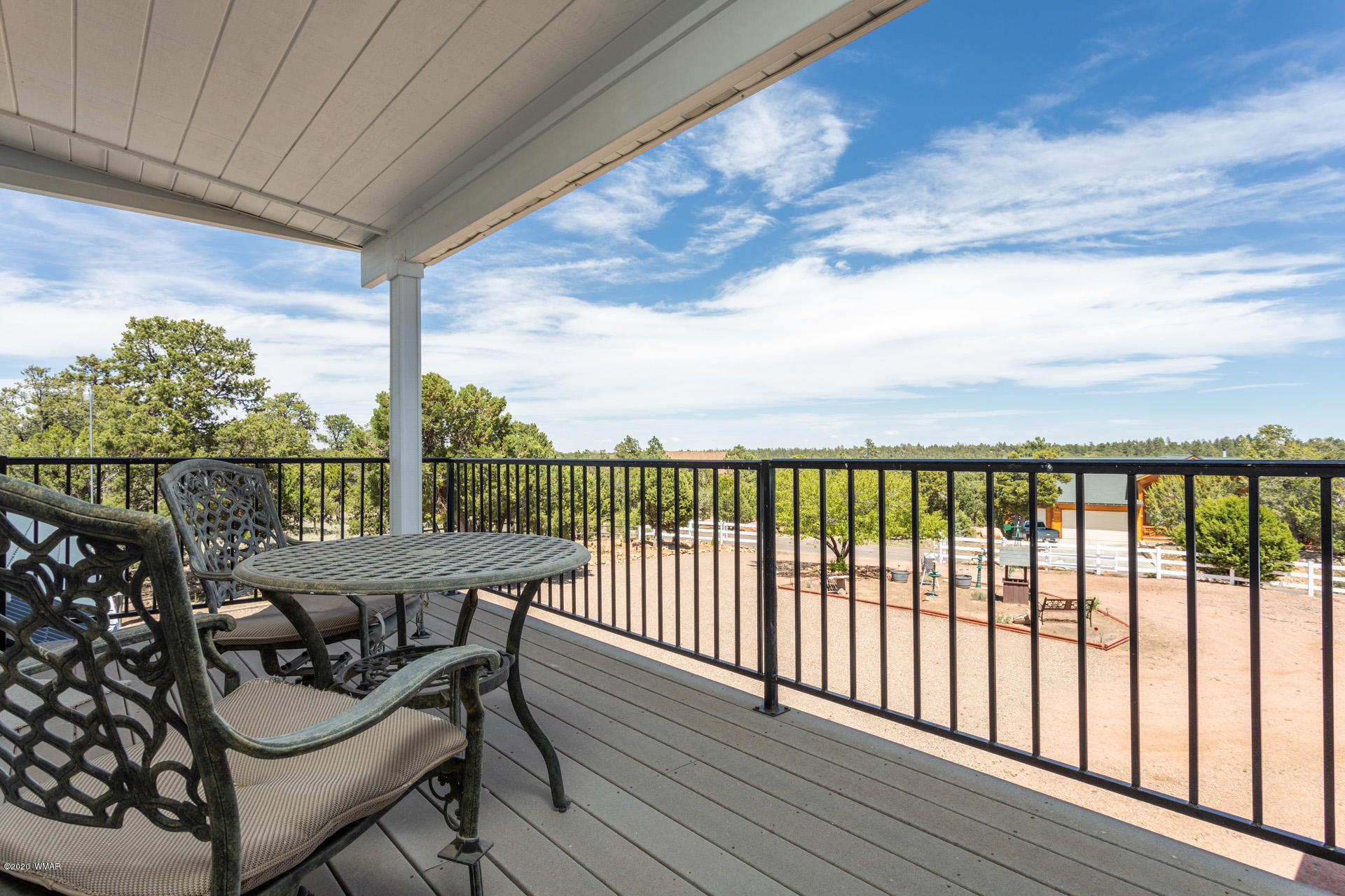 2974 Ranch House Road Overgaard, AZ 85933 - Photo 46 of 46 a balcony with wooden floor table and chairs