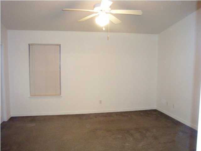 514 Keystone Road, Unit 514 Mary Esther, FL 32569 - Photo 4 of 10 an empty room with a fan and a window