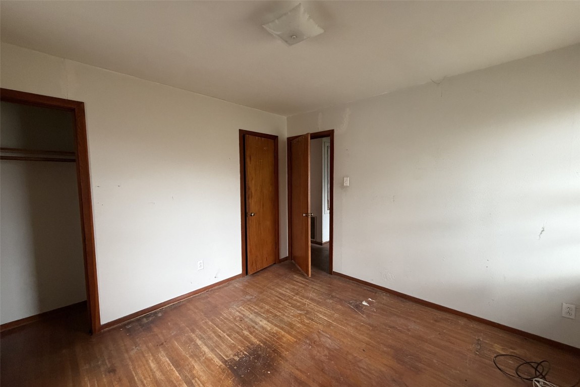 3207 Washington Street Pasadena, TX 77503 - Photo 9 of 9 a view of an empty room with wooden floor and a window