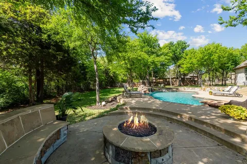 a swimming pool with outdoor seating and yard
