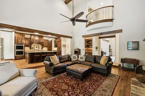 a living room with fireplace furniture and a large window