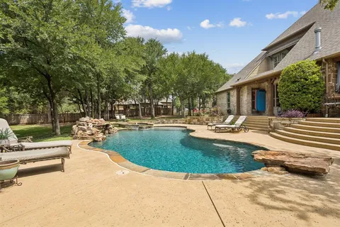 a swimming pool with outdoor seating and yard