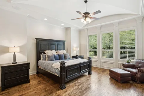 a bedroom with a bed and a television