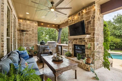 a living room with furniture a flat screen tv and a fireplace