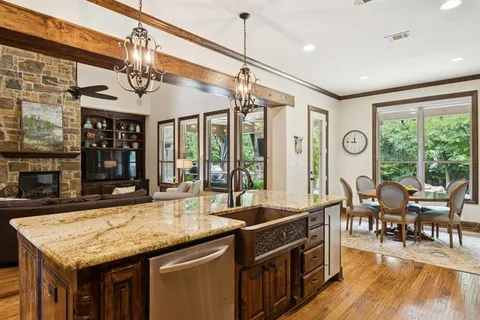 a kitchen with granite countertop a stove and cabinets