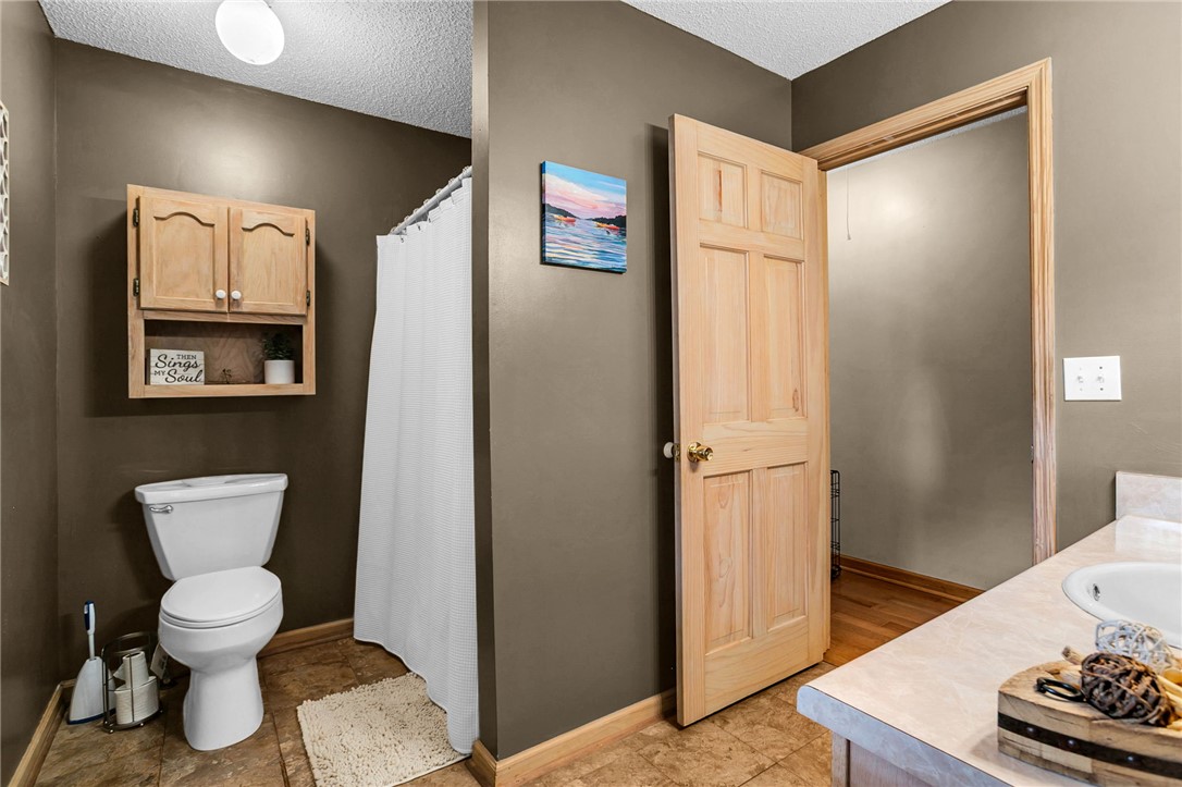 130 Greenbrier Road Salem, SC 29676 - Photo 44 of 48 This bathroom features durable tile flooring and a functional wooden cabinet for storage.