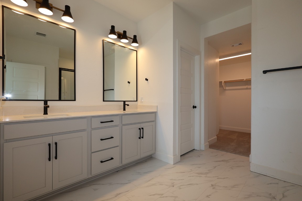 830 Nadal Path Round Rock, TX 78664 - Photo 3 of 15 a bathroom with a double vanity sink and mirror