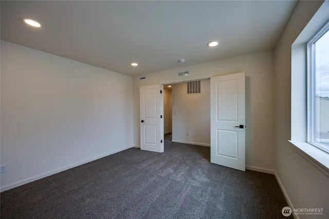 a view of an empty room and a window
