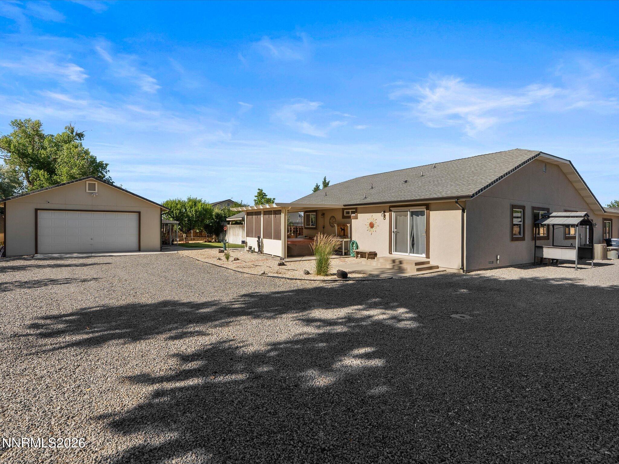 1080 Red Rock Road Fernley, NV 89408 - Photo 41 of 45 a front view of a house with a yard and garage