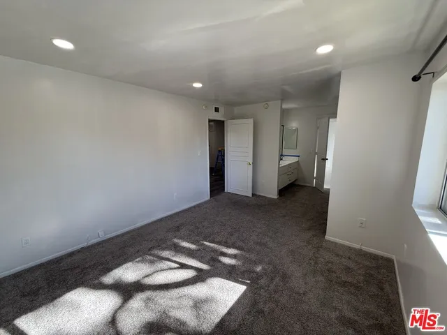 a view of a big room with a kitchen