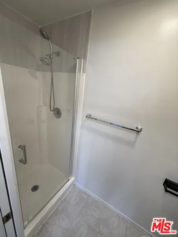 a bathroom with a glass shower door