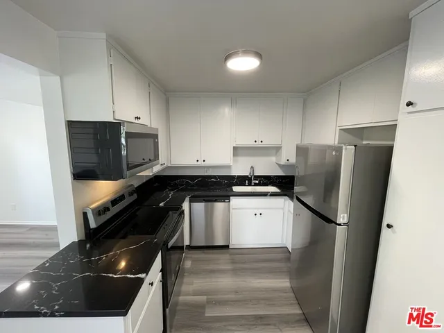 a kitchen with a refrigerator and a sink