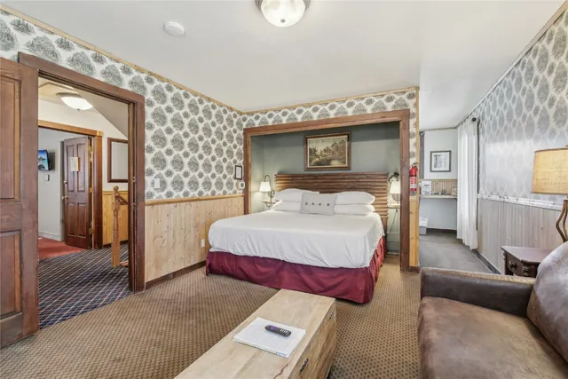 a bed room with a bed couch and a window