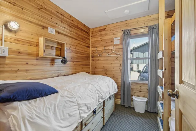 a kitchen with a wooden floor and a large window