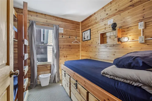 a bedroom with furniture and wooden floor
