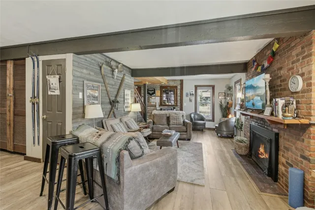 a dining hall with stainless steel appliances granite countertop a stove a sink and a refrigerator