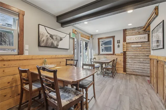 a view of a workspace with furniture and wooden floor