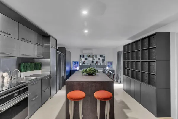 a kitchen with granite countertop a sink stainless steel appliances and cabinets
