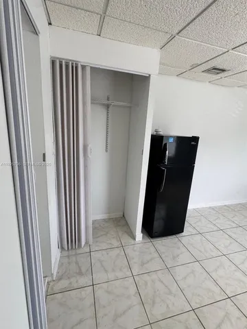 a view of a utility room with cabinet