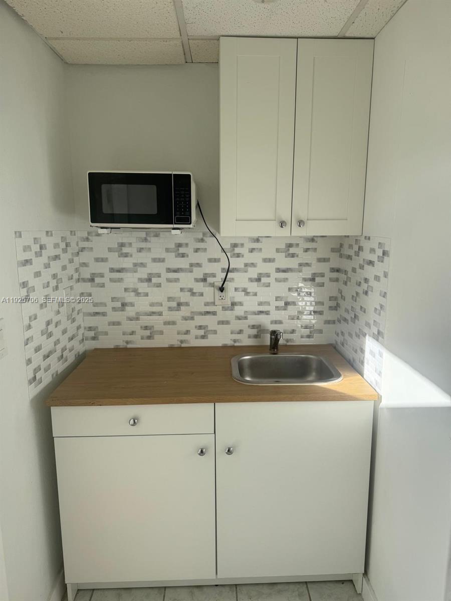 14281 Southwest 285th Street Homestead, FL 33033 - Photo 3 of 6 a bathroom with a sink and a microwave