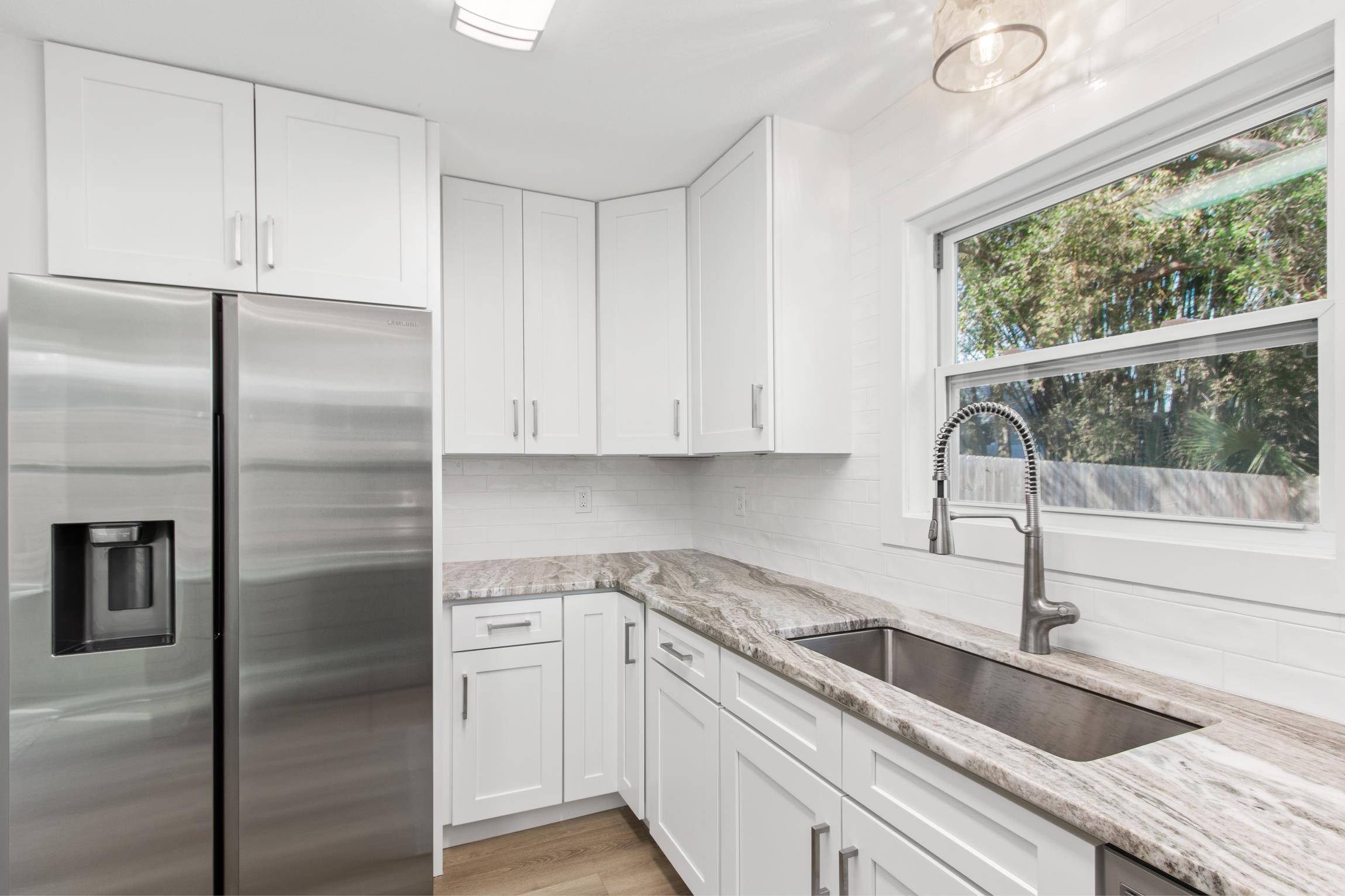 112 2nd Street St. Augustine, FL 32080 - Photo 14 of 49 a kitchen with a refrigerator sink and cabinets