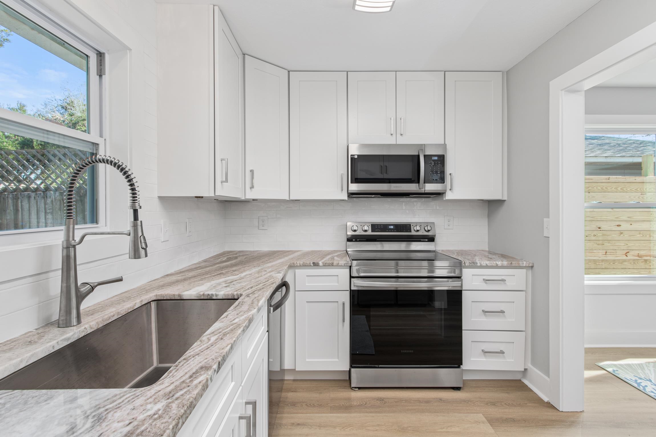 112 2nd Street St. Augustine, FL 32080 - Photo 15 of 49 a kitchen with stainless steel appliances granite countertop a stove and a sink