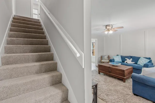 a living room with furniture and stairs