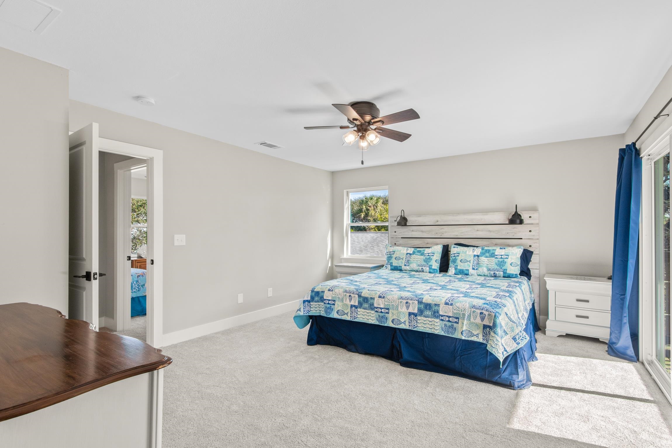 112 2nd Street St. Augustine, FL 32080 - Photo 21 of 49 a bedroom with a bed a chandelier and a dresser