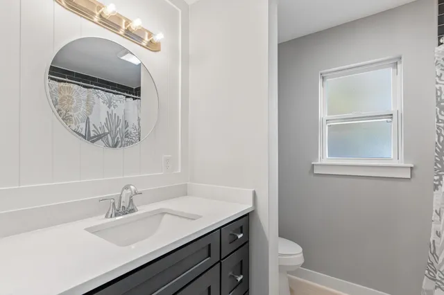 a bathroom with a sink vanity and a mirror